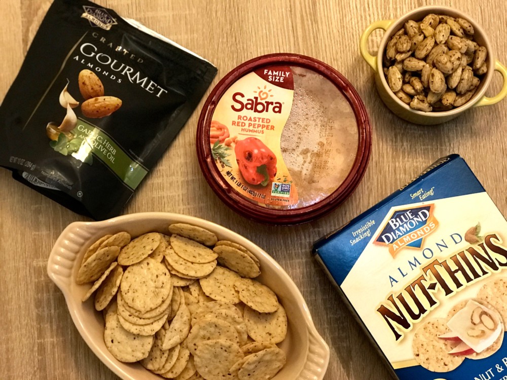 Sabra Roasted Red Pepper Hummus, Blue Diamond Nut-Thins, Blue Diamond Gourmet Garlic, and Herb Olive Oil Almonds